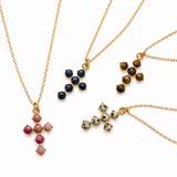 4 of stone bead cross pendants on gold chain. white background