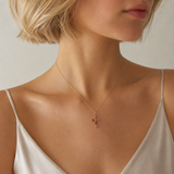 cross pendant necklace on model's neck.