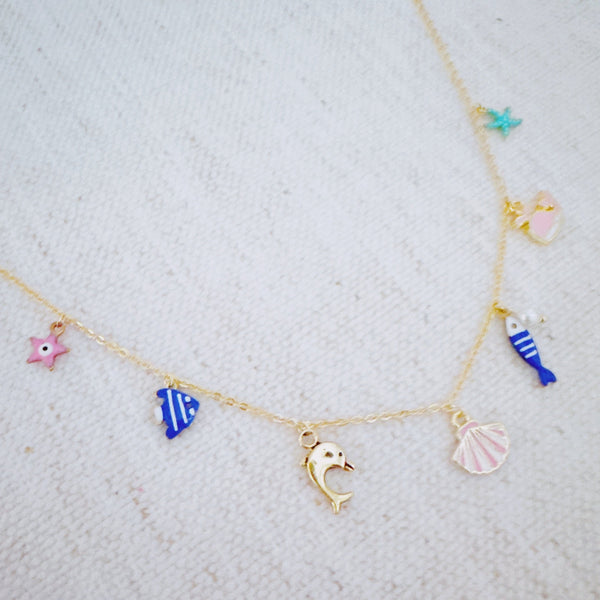 Gold brass necklace with colorful fish, shell, and sea animal charms