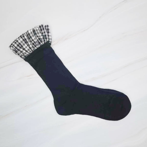 Elegant plaid socks featuring delicate ruffle trim at the top—combining classic style with a chic, feminine twist.