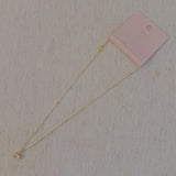 Gold-tone necklace featuring an oval-cut pendant with a sparkling crystal center, offering a refined and elegant touch.