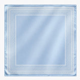 Light blue fabric square with decorative white border