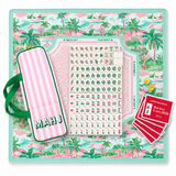 Ellison+Young Palm Resort Mahjong Playing Mat shown with a full tile set, dice, and score cards arranged on top.