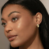 Pair of elegant interlocking loop earrings encrusted with shimmering pavé crystals. The design features two linked ovals forming a sculptural, modern silhouette with a refined, high-shine finish that catches the light beautifully.