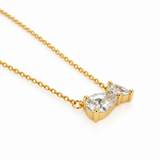 Angled detail of the two pear-cut cubic zirconia stones showing polished gold prong settings