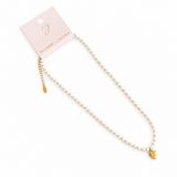 Gold necklace with heart pendant on a white background