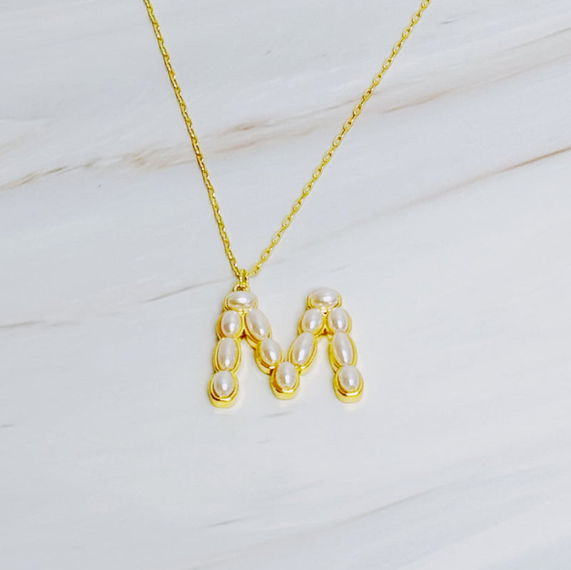 Gold chain necklace featuring an elegant initial pendant inlaid with pearl mosaic accents for a personalized, sophisticated touch.