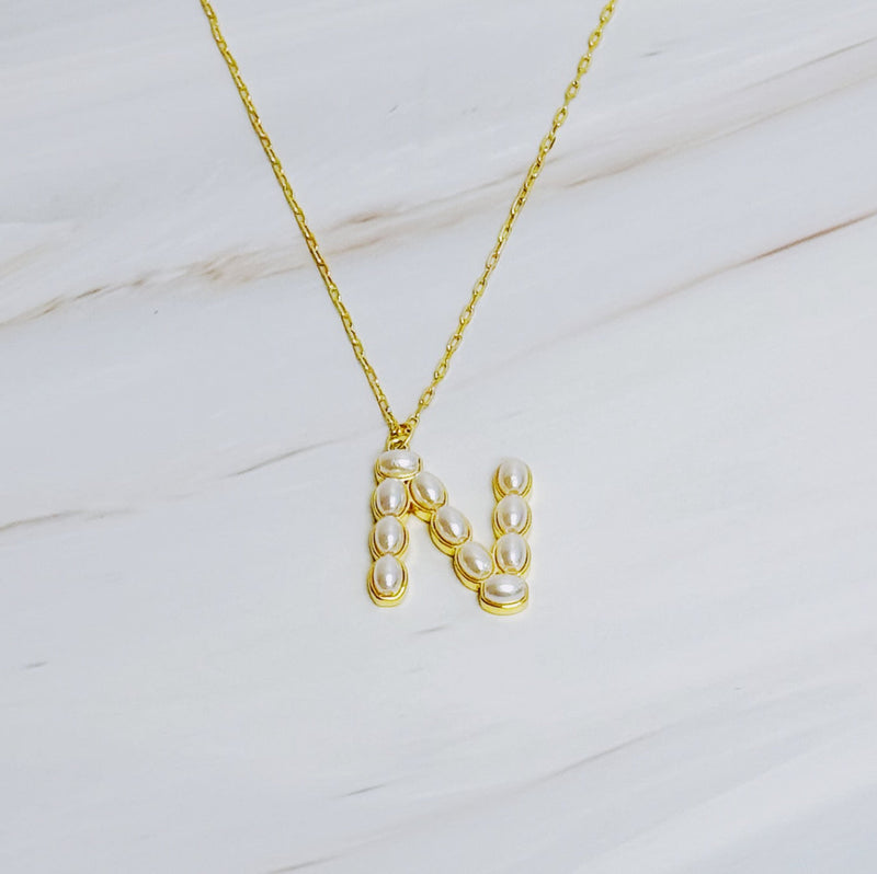 Gold chain necklace featuring an elegant initial pendant inlaid with pearl mosaic accents for a personalized, sophisticated touch.