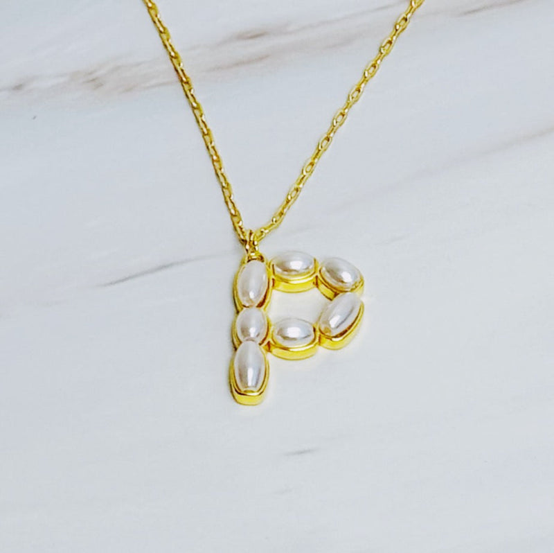 Gold chain necklace featuring an elegant initial pendant inlaid with pearl mosaic accents for a personalized, sophisticated touch.