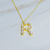 Gold chain necklace featuring an elegant initial pendant inlaid with pearl mosaic accents for a personalized, sophisticated touch.