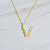 Gold chain necklace featuring an elegant initial pendant inlaid with pearl mosaic accents for a personalized, sophisticated touch.
