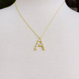 Gold chain necklace featuring an elegant initial pendant inlaid with pearl mosaic accents for a personalized, sophisticated touch.