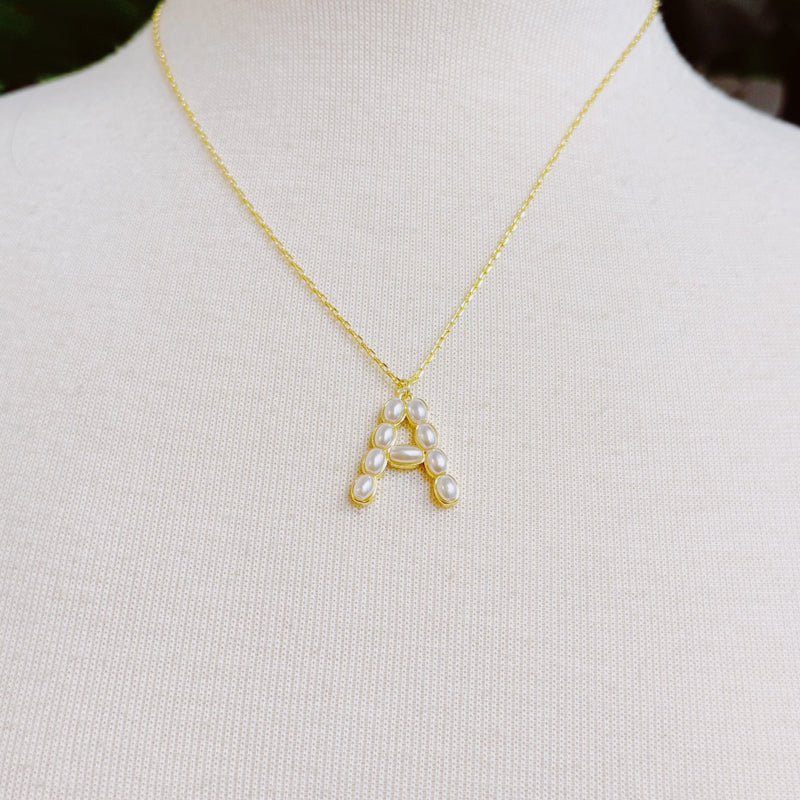 Gold chain necklace featuring an elegant initial pendant inlaid with pearl mosaic accents for a personalized, sophisticated touch.