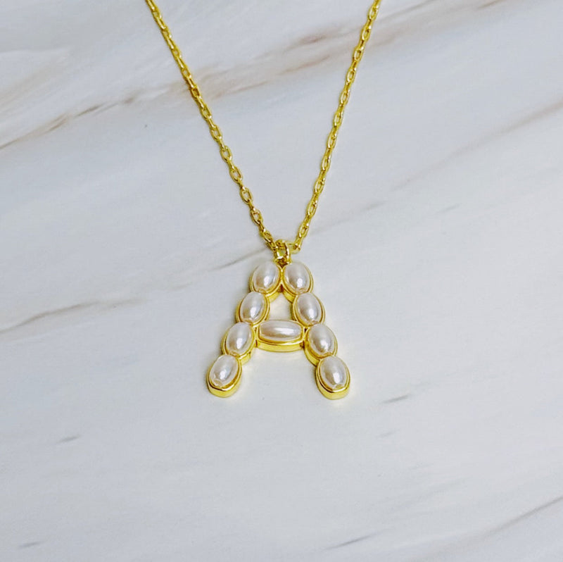 Gold chain necklace featuring an elegant initial pendant inlaid with pearl mosaic accents for a personalized, sophisticated touch.