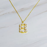 Gold chain necklace featuring an elegant initial pendant inlaid with pearl mosaic accents for a personalized, sophisticated touch.