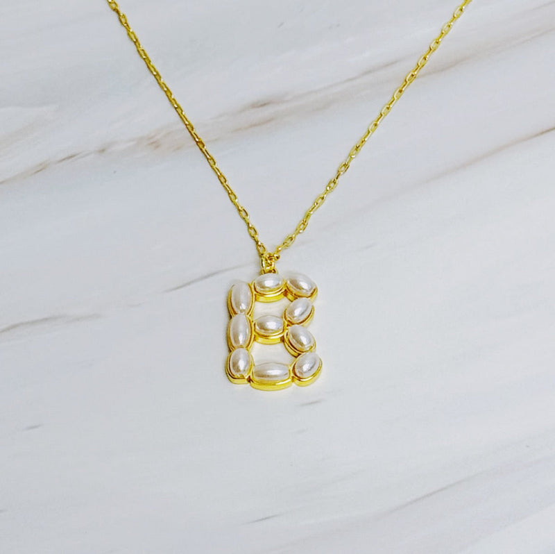 Gold chain necklace featuring an elegant initial pendant inlaid with pearl mosaic accents for a personalized, sophisticated touch.