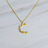 Gold chain necklace featuring an elegant initial pendant inlaid with pearl mosaic accents for a personalized, sophisticated touch.