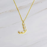 Gold chain necklace featuring an elegant initial pendant inlaid with pearl mosaic accents for a personalized, sophisticated touch.