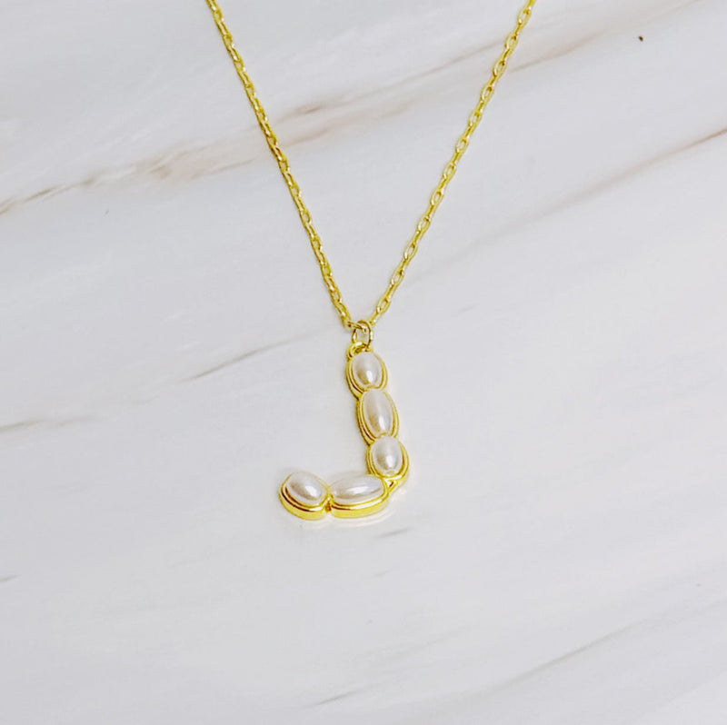 Gold chain necklace featuring an elegant initial pendant inlaid with pearl mosaic accents for a personalized, sophisticated touch.