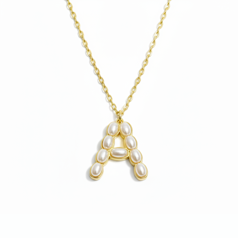 Gold necklace with a pendant shaped like the letter 'A' on a white background