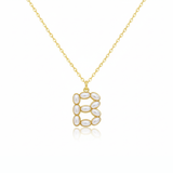 Gold necklace with a pendant shaped B on a white background