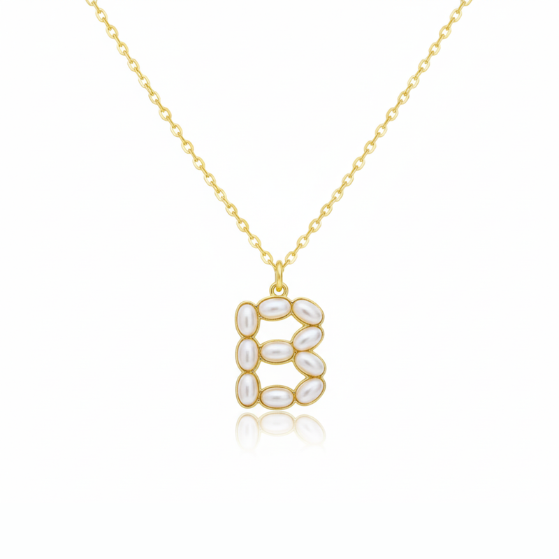 Gold necklace with a pendant shaped B on a white background