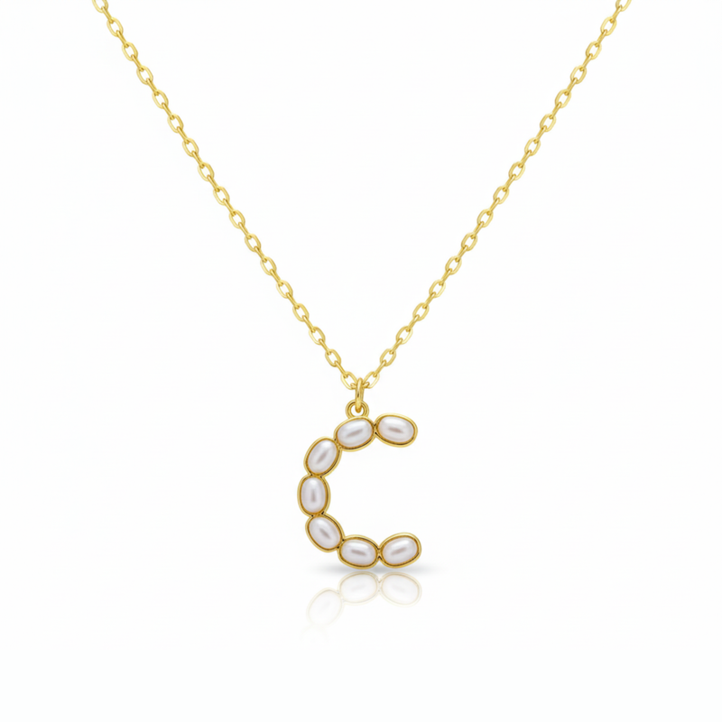Gold necklaces with pearl-like beads on a initial pendant C with white background