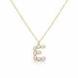 Gold necklaces with pearl-like beads on a initial pendant E with white background