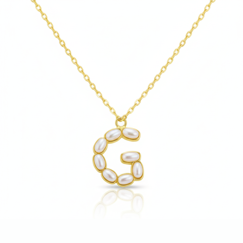 Gold necklaces with pearl-like beads on a initial pendant G with white background
