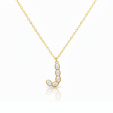Gold necklaces with pearl beads on a initial pendant J with white background