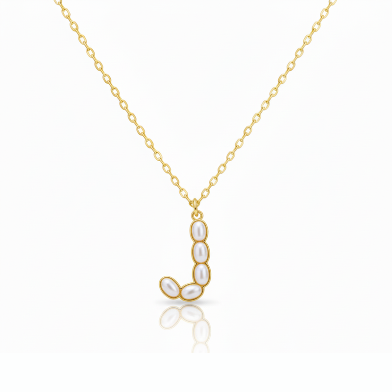 Gold necklaces with pearl beads on a initial pendant J with white background