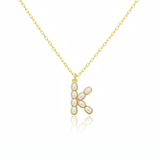 Gold necklaces with pearl beads on a initial pendant H with white background