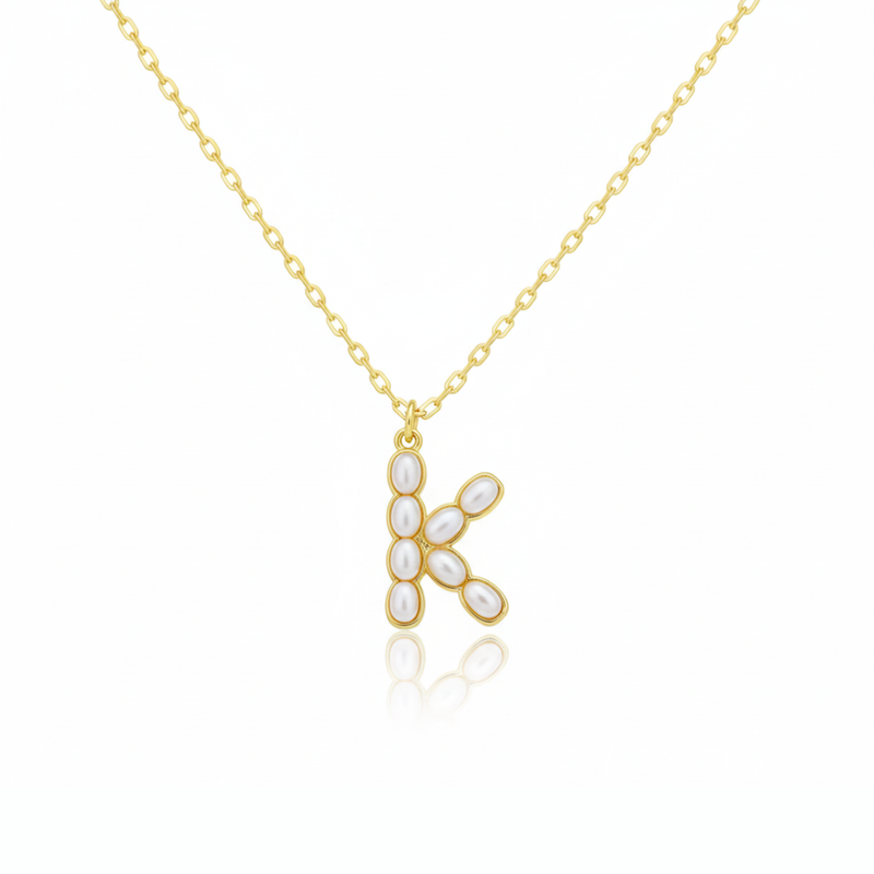 Gold necklaces with pearl beads on a initial pendant H with white background