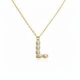 Gold necklaces with pearl beads on a initial pendant L with white background