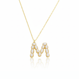Gold necklaces with pearl beads on a initial pendant M with white background