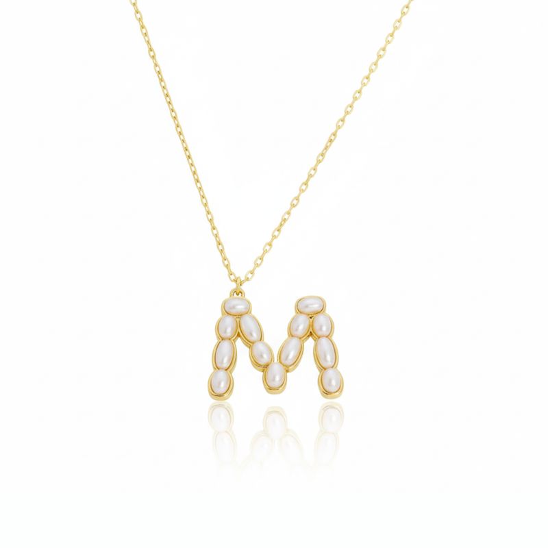 Gold necklaces with pearl beads on a initial pendant M with white background