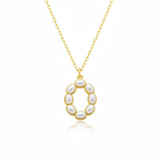 Gold necklaces with pearl beads on a initial pendant O with white background