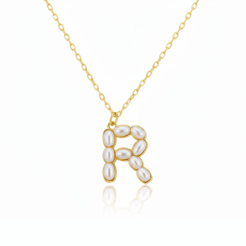 Gold necklaces with pearl beads on a initial pendant R with white background