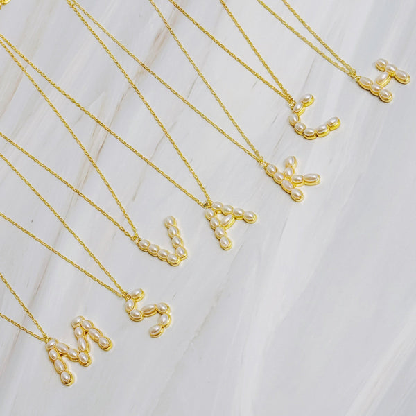 Gold chain necklace featuring an elegant initial pendant inlaid with pearl mosaic accents for a personalized, sophisticated touch.