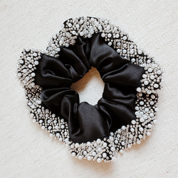  Elegant satin hair scrunchie embellished with delicate pearls and beads—adding a touch of sophistication and shine to any hairstyle.