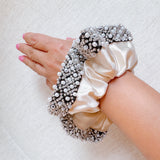  Elegant satin hair scrunchie embellished with delicate pearls and beads—adding a touch of sophistication and shine to any hairstyle.