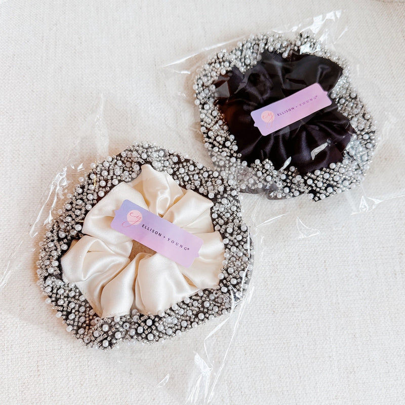  Elegant satin hair scrunchie embellished with delicate pearls and beads—adding a touch of sophistication and shine to any hairstyle.