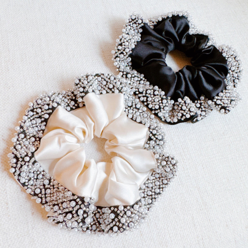  Elegant satin hair scrunchie embellished with delicate pearls and beads—adding a touch of sophistication and shine to any hairstyle.