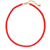 Close-up of a bold red beaded necklace featuring uniformly round, glossy beads strung together in a classic strand, creating a vibrant and timeless accessory.