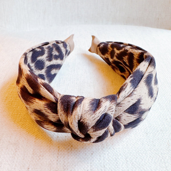 Fashion-forward headband featuring a classic leopard print on a sleek, structured band—offering a perfectly chic accent for everyday or statement styling.