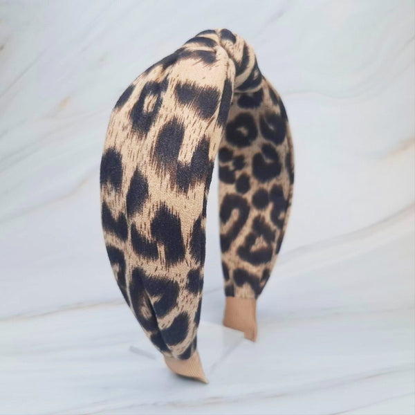 Fashion-forward headband featuring a classic leopard print on a sleek, structured band—offering a perfectly chic accent for everyday or statement styling.