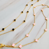 Delicate layered chain bracelet featuring a petite clover charm centerpiece, offering a minimalist and feminine touch with a refined gold-tone finish.