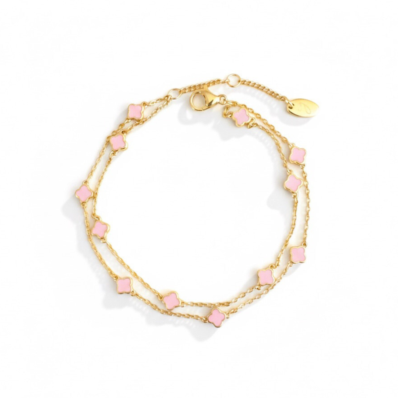 Delicate layered chain bracelet featuring a petite clover charm centerpiece, offering a minimalist and feminine touch with a refined gold-tone finish.
