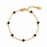 Delicate gold bracelet featuring a petite clover charm on a single fine chain. The minimalist design adds a touch of everyday elegance with its subtle shine and timeless silhouette, perfect for layering or wearing solo.