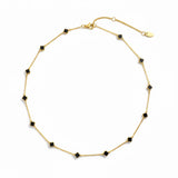 Gold-toned necklace featuring a delicate colored clover pendant, suspended on a fine chain for a soft pop of charm and color.